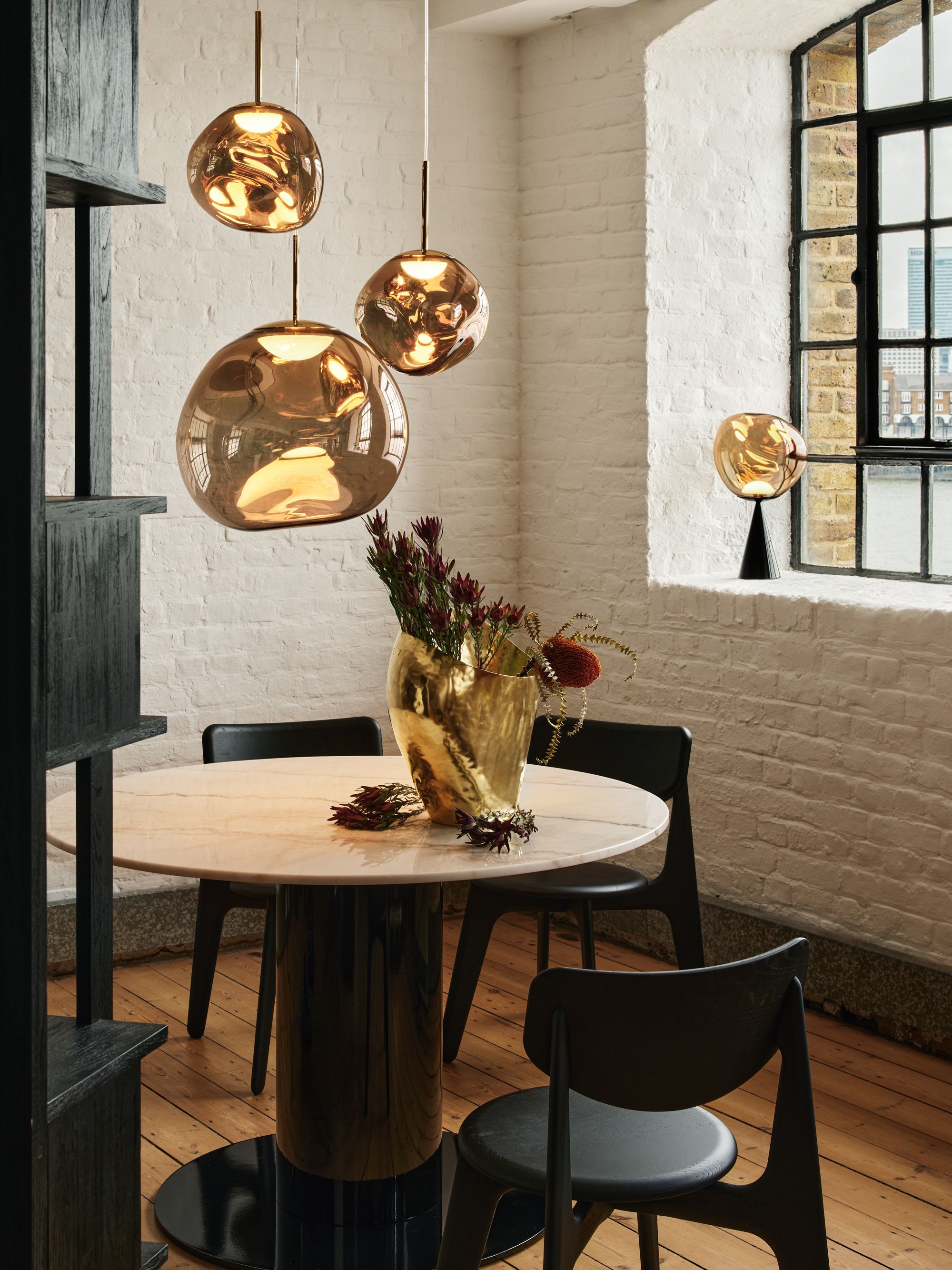 Tom Dixon Tube dining table with Melt pendants in a riverside interior